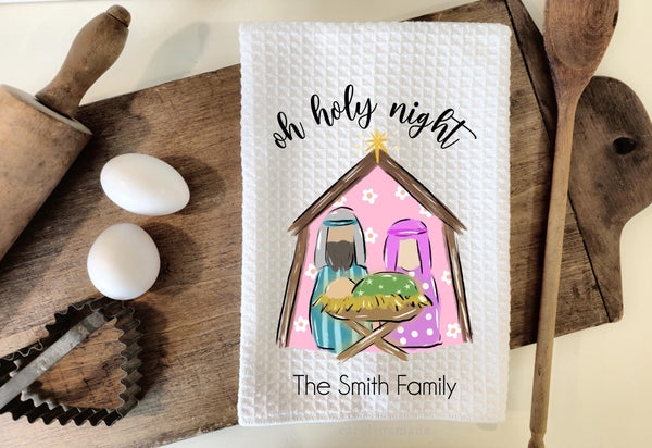 This white waffle weave towel features a manager scene with Joseph, Mary and Jesus. The top says Oh holy night and the bottom is personalized with your family name.