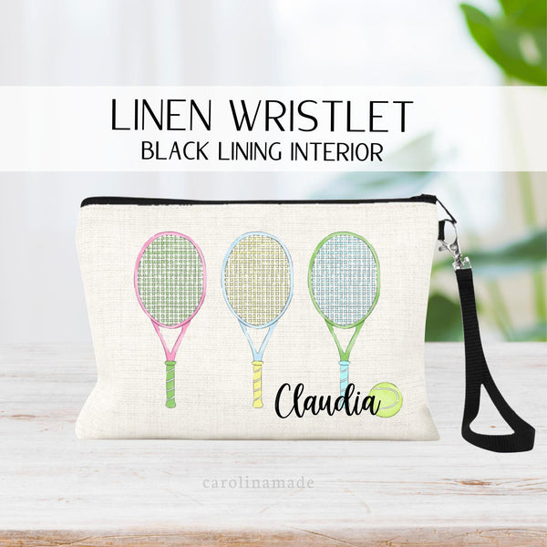 This linen bag features three colorful tennis rackets in a row in the center of the bag. At the bottom right corner it is personalized with your name and a tennis ball.
