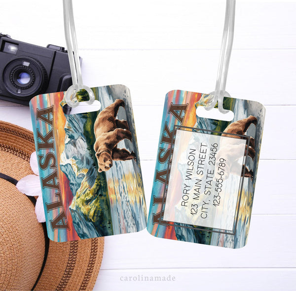 This metal bag tag features an Alaska scene with water, mountains, and a bear. Personalize the back with your contact information.