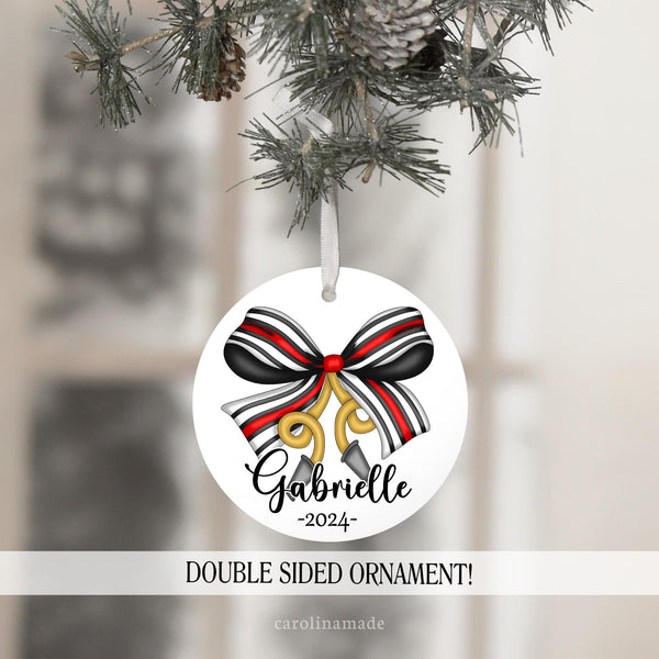 This ornament features a large bow in fire fighter colors and also has a fire truck hose hanging off of it. It is personalized at the bottom with name and year.