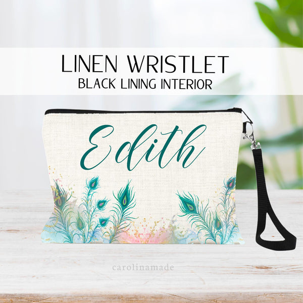 Personalized peacock make up bag wristlet. Colorful peacock feathers across the bottom with the name above them.