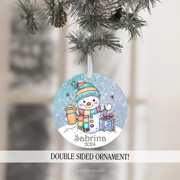 This fun Christmas ornament features a colorful snowman design with hat, presents, snow a scarf and hot latte drink. It is personalized at the bottom with childs name and the year.