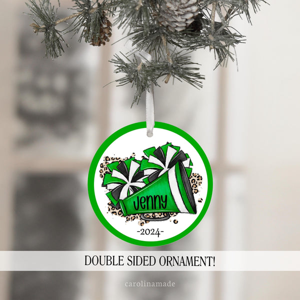This ornament features a cheer design with mega phone and pom poms. It is personalized in the center with your name and the year. The ornament is double sided and is made in your team colors