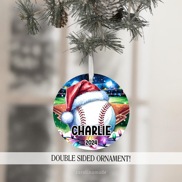 This Christmas ornament features a large baseball with a Santa hat in a baseball stadium with Christmas lights. It is personalized with your baseball players name and the year at the bottom.