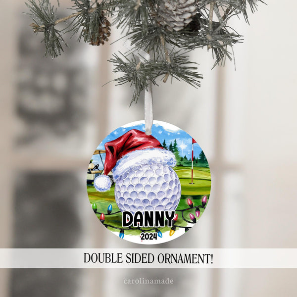 This Christmas ornament features a large golf ball with a Santa hat on a golf course with golf cart and hole with Christmas lights. It is personalized with your golf players name and the year at the bottom.
