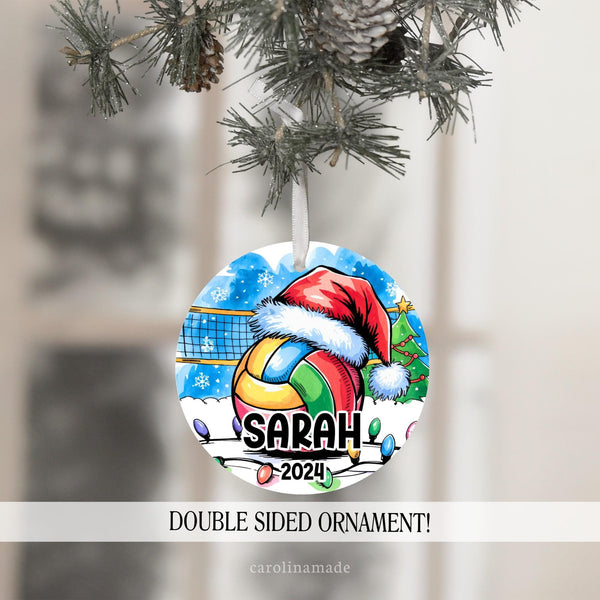 This Christmas ornament features a large volleyball with a Santa hat in a snowy outdoor volleyball court with Christmas lights. It is personalized with your volleyball players name and the year at the bottom.