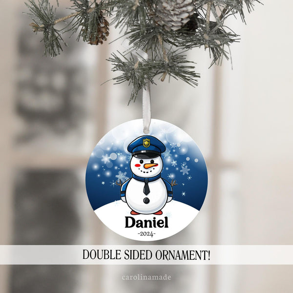 This ornament features a dark blue snowy background with a police man snowman in the center. It is personalized at the bottom with your name and the year. Perfect gift for police officer or child who loves police!