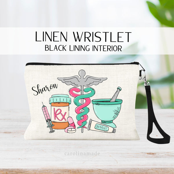 This linen wristlet features a pharmacy design with a medical symbol, a RX bottle, a needle, pills, ointment and a mixing bowl. It is personalized with your name in the top corner.