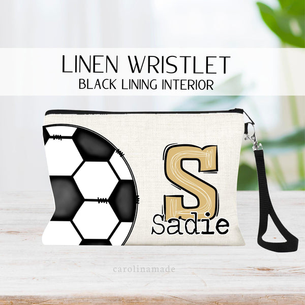 This linen wristlet features a large soccer ball covering the left side of the bag. On the right side shows a large Initial in a fun Varsity style font with the name under it. There are other options to do jersey # or school abbreviation also.