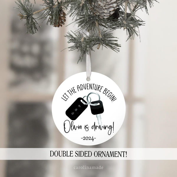 Minimalist Christmas Ornament with white and black design. Let the adventure begin! With keys and remote in the center. It is personalized at the bottom with your teens name and the year.