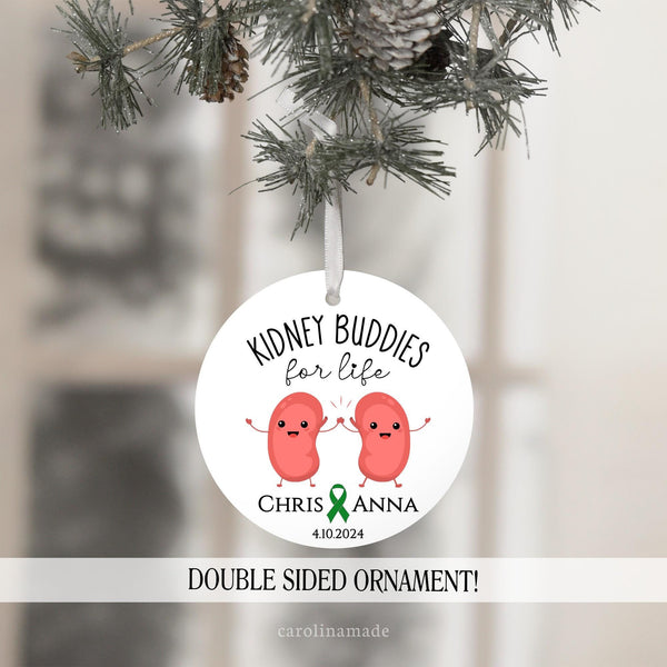 This ornament features two kidney buddies holding hand and is personalized at the bottom with your names, a green or orange ribbon, and the date of the transplant.