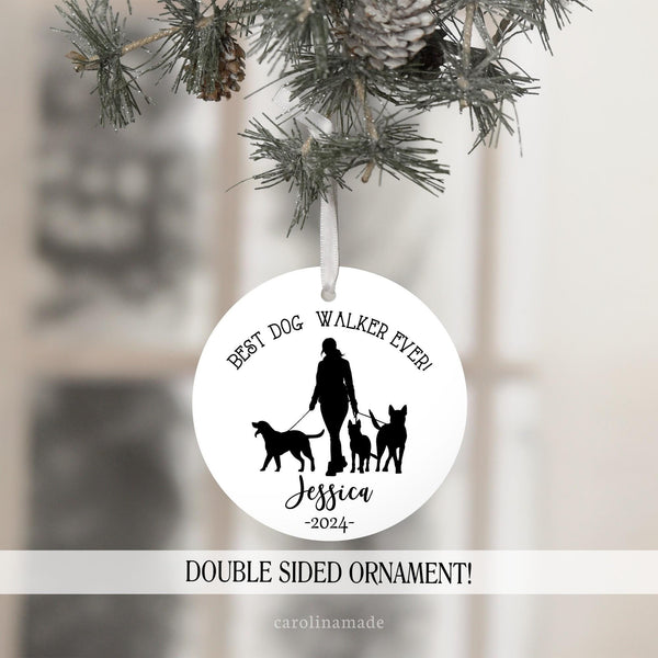 This ornament features a black and white minimalist style design with a woman walking three dogs in the center. Top says Best Dog Walker Ever. And the bottom is personalized with name and year.