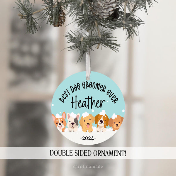 This ornament features dogs along the bottom with suds and bubbles. The top says best dog groomer ever. It is personalized in the center with your name and the year at the bottom.