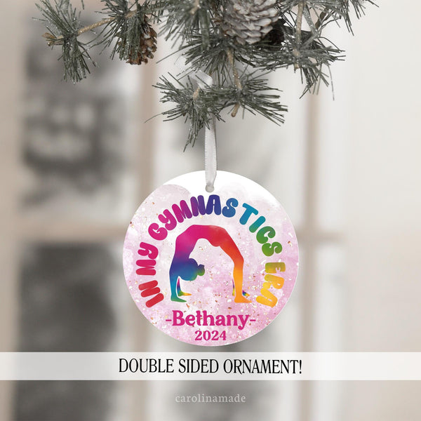 This fun girls gymnast ornament features a rainbow design with a gymnast girl silhouette and text that says In my Gymnastics Era. It is personalized at the bottom with name and year.