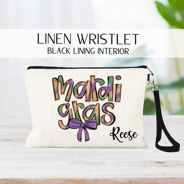 This linen wristlet features the word mardi gras in colors of purple, green and yellow. It has a purple couqette bow under it. It is personalized with your name. Perfect girls trip zipper pouch!