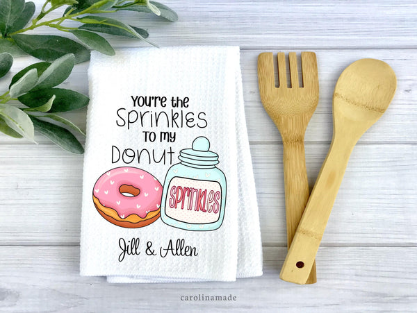 This white waffle weave towel features the cutest food pun that says Youre the sprinkles to my donut. It is personalized at the bottom with your name.