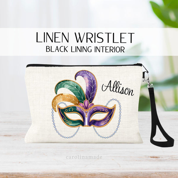 This linen zipper pouch is the perfect accessory for your trip to Mardi Gras! It features a mardi gras mask in yellow, green and purple colors with beads hanging off it. It is personalized with your name on the top corner.