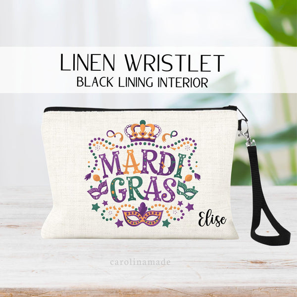 This linen wristlet features the word mardi gras colors of purple, green and yellow with beads, mask, crown and stars all around it. It is personalized with your name in the corner. Perfect girls trip zipper pouch!