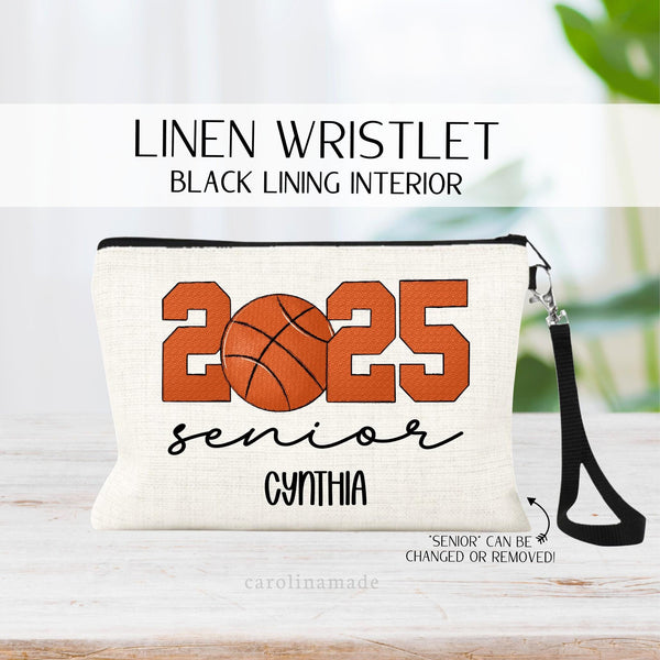 This linen zipper pouch features 2025 in the center in basketball colored letters and the word senior at the bottom. Personalize the bag with a name at the bottom.