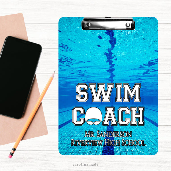 This double sided clipboard features a competition pool background. It says Swim Coach and is personalized at the bottom with your coachs name and the school or club name.