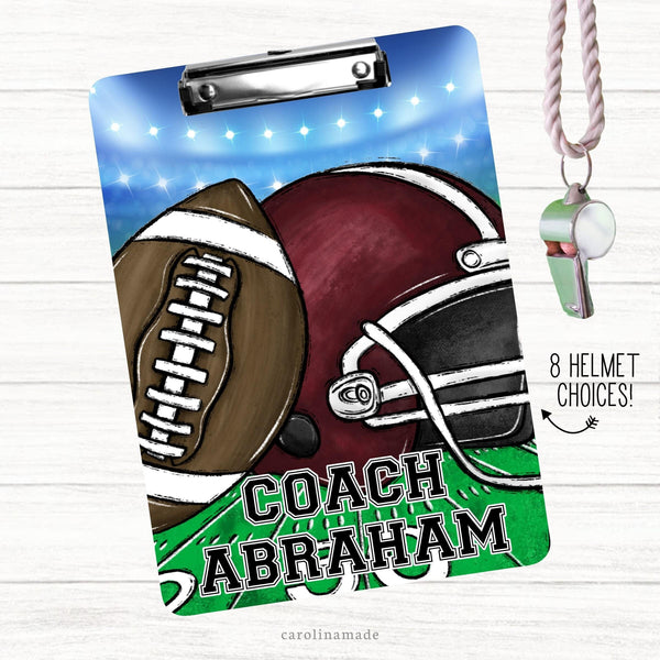 This double sided clipboard features a fun coach design with stadium lights, a football, a helmet and the lined grass. It is personalized at the bottom.
