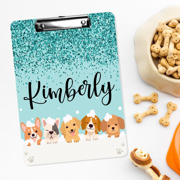 This double sided clipboard features dogs at lined at the bottom in a bath with bubbles. The top has a teal glitter overlay and your name is personalized in the center.