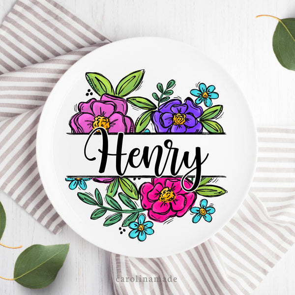 This white plate features a beautiful floral design that is split in the center to add your family last name.  The pink, purple and blue flowers with greenery are vibrant!
