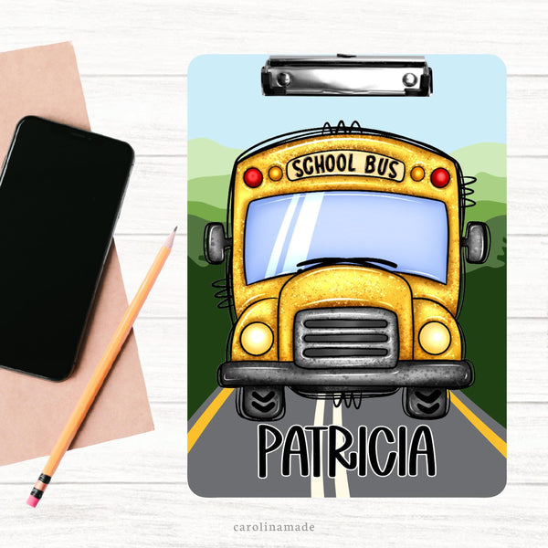 This double sided clipboard features a road and landscape background with a large school bus in the center and it is personalized at the bottom with your bus drivers name.