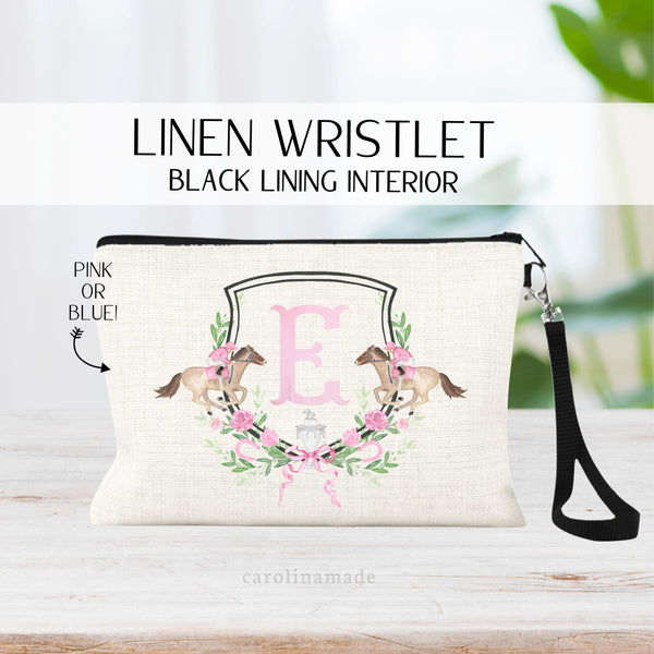 This linen wristlet features a pink floral crest with your initial in the center. There are two derby horses  on the side. perfect kentucky derby day zipper pouch