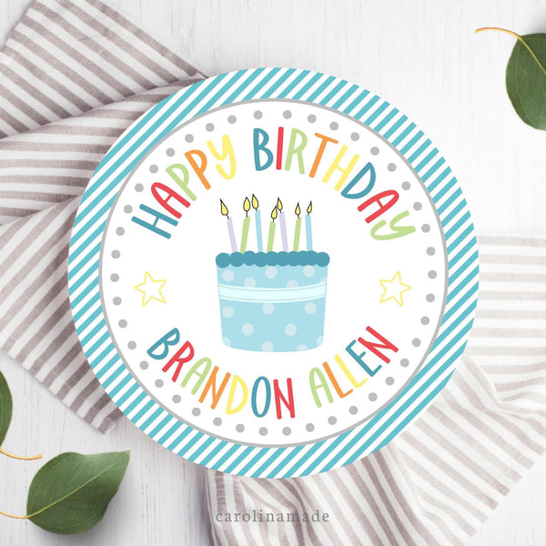This 10 inch plate features a blue diagonal stripe background with a white circle in the center and a blue cake with colorful text that says happy birthday and is personalized with your childs name.