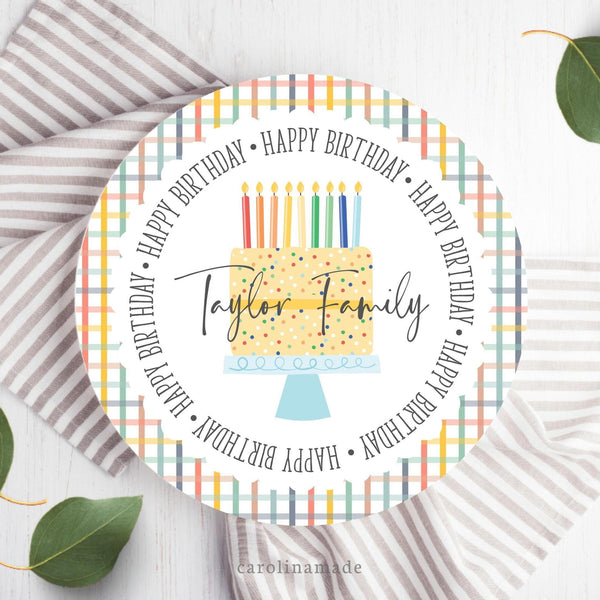 This 10 inch plate features a colorful plaid background. The center is personalized with your family name over a rainbow cake and it says happy birthday in a circle around the plate.