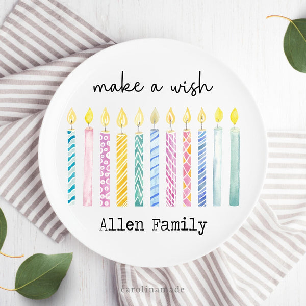 This plate features a row of colorful watercolor candles in the center. The top says Make a wish. And the bottom is personalized with your family name.