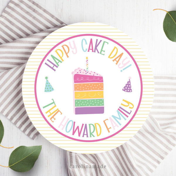 This family celebration plate features a yellow striped background border with a colorful cake in the center. The top says Happy Cake Day and the bottom is personalized with your familys name.