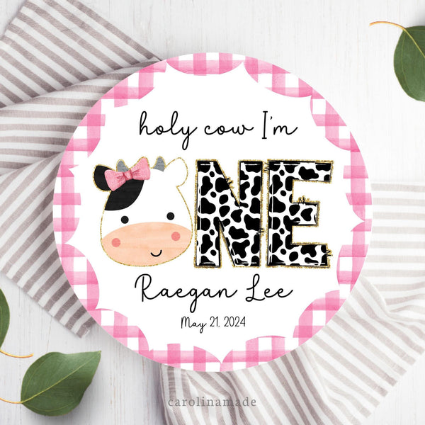 This Holy Cow I'm One theme birthday plate features a pink gingham scallop boarder with a cow in the center. The bottom is personalized with your childs name and date of birth.