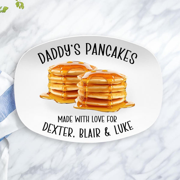 This white serving platter features two large stacks of pancakes with syrup in the center. The top text says Daddys Pancakes and the bottom says Made with love and is personalized with your childrens names.