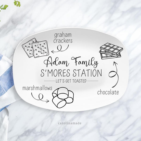 This 10x14 inch platter features a modern minimalist feel with outline of items to make smores. Graham crackers, chocolate and marshmallows. The center is personalized with your family name. and says Smore station, lets get toasted.