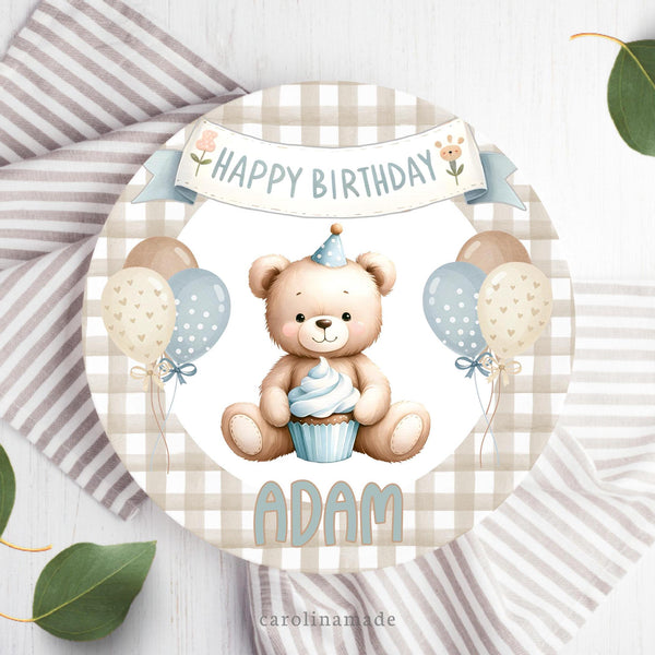This 10 inch plate features a boho theme with beige gingham background with a teddy bear  wearing a birthday hat and cupcake with balloons in the center. The top says happy birthday and bottom is personalized with your childs name.