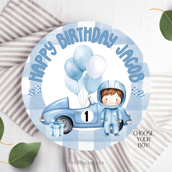 This ten inch plate features a gingham blue outer ring with white center background. It has clipart for a boys blue race car them birthday. Car, Balloons, Flags and present. The top says Happy Birthday and is personalized with the childs name.