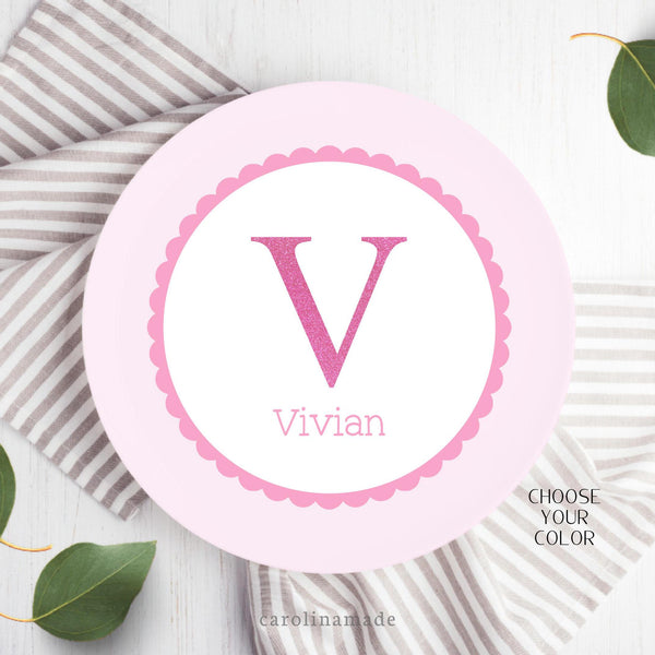 Choose your color on this 10 inch childs name plate! Main plate shown has an outer light pink ring with darker pinks scallop ring. The center has a glitter initial with child's name under it. Choose from shades of pink, blue, purple and teal.