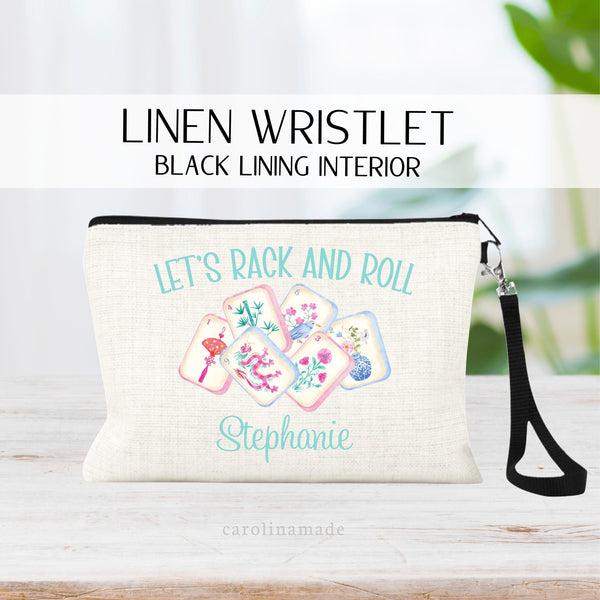 Personalized linen zipper pouch perfect for mahjong game night! This bag features a watercolor set of tiles in the center. The top says Lets rack and roll. The bottom has your name on it.
