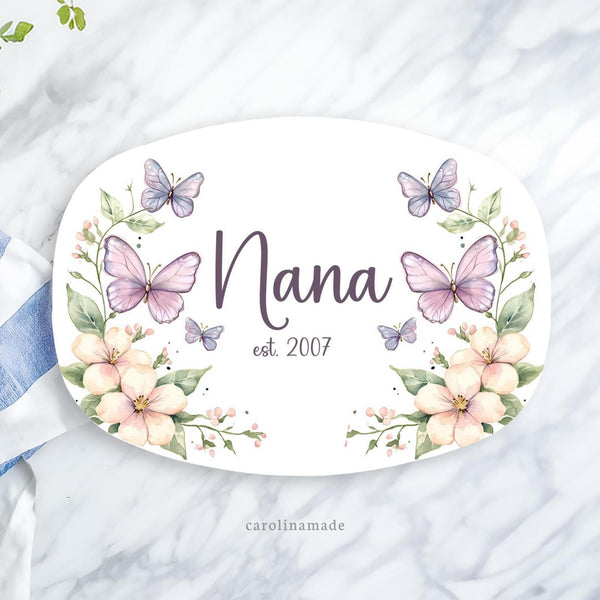This 10 x 14 inch platter features a white background with flowers and greenery on both sides with two butterflies on each side as well. The center has your personalized name and the established date.
