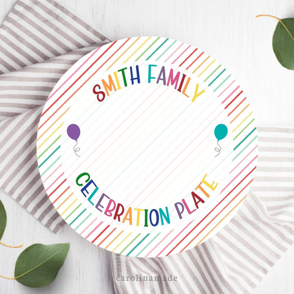 This 10 inch plate features a striped background with rainbow color text. The top is personalized with your family name and the bottom says celebration plate.