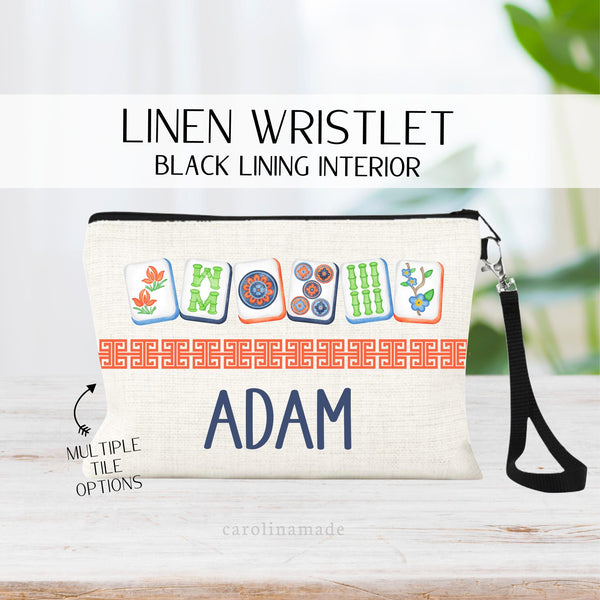 This linen wristlet zipper pouch features a mahjong cards at the top with a Chinese border in the middle and personalized name at the bottom. Choose from multiple mahjong color sets for men and women.