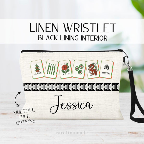 This linen wristlet zipper pouch features a mahjong cards at the top with a Chinese border in the middle and personalized name at the bottom. Choose from multiple mahjong color sets for men and women.