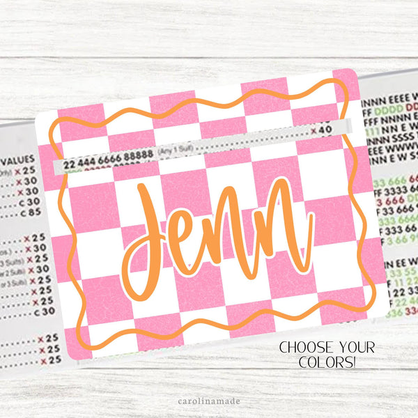 This acrylic mahjong line reader features a white and pink checkered background with orange wavy border. The center is personalization with your name. Choose your color of checker and text color.  Several mahjong zipper pouches available also.
