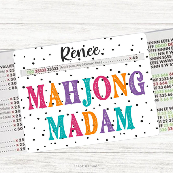 This acrylic mahjong line reader features a white background with black dots and colorful text that says Mahjong Madam. The top is personalization with your name. Matching zipper pouch available also.
