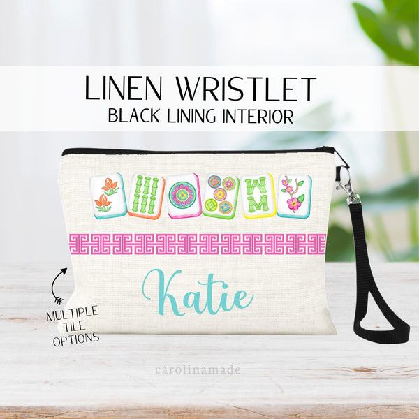 This linen wristlet zipper pouch features a mahjong cards at the top with a Chinese border in the middle and personalized name at the bottom. Choose from multiple mahjong color sets for men and women.