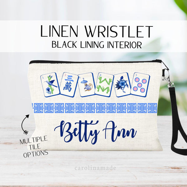 This linen wristlet zipper pouch features a mahjong cards at the top with a Chinese border in the middle and personalized name at the bottom. Choose from multiple mahjong color sets for men and women.