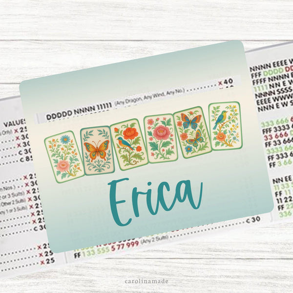 This acrylic mahjong line reader features a teal & cream ombre background with 6 vintage looking floral and butterfly colorful mahjong tiles and your name personalized at the bottom. Matching zipper pouch available also.