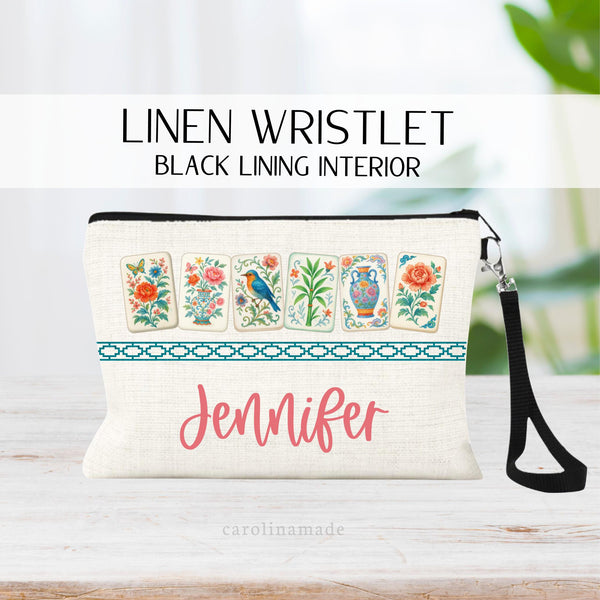 This linen zipper pouch is perfect for mahjong game night and features floral mahjong tiles with a Chinese border and your name is personalized at the bottom.